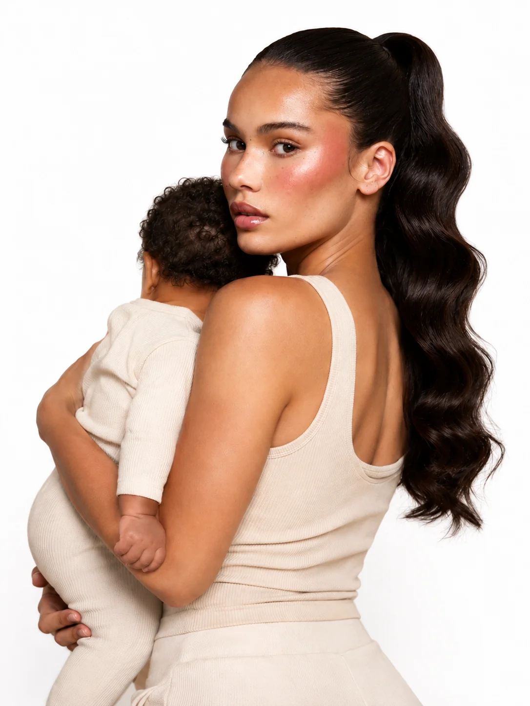 Postpartum mother holding her baby and looking over her shoulder